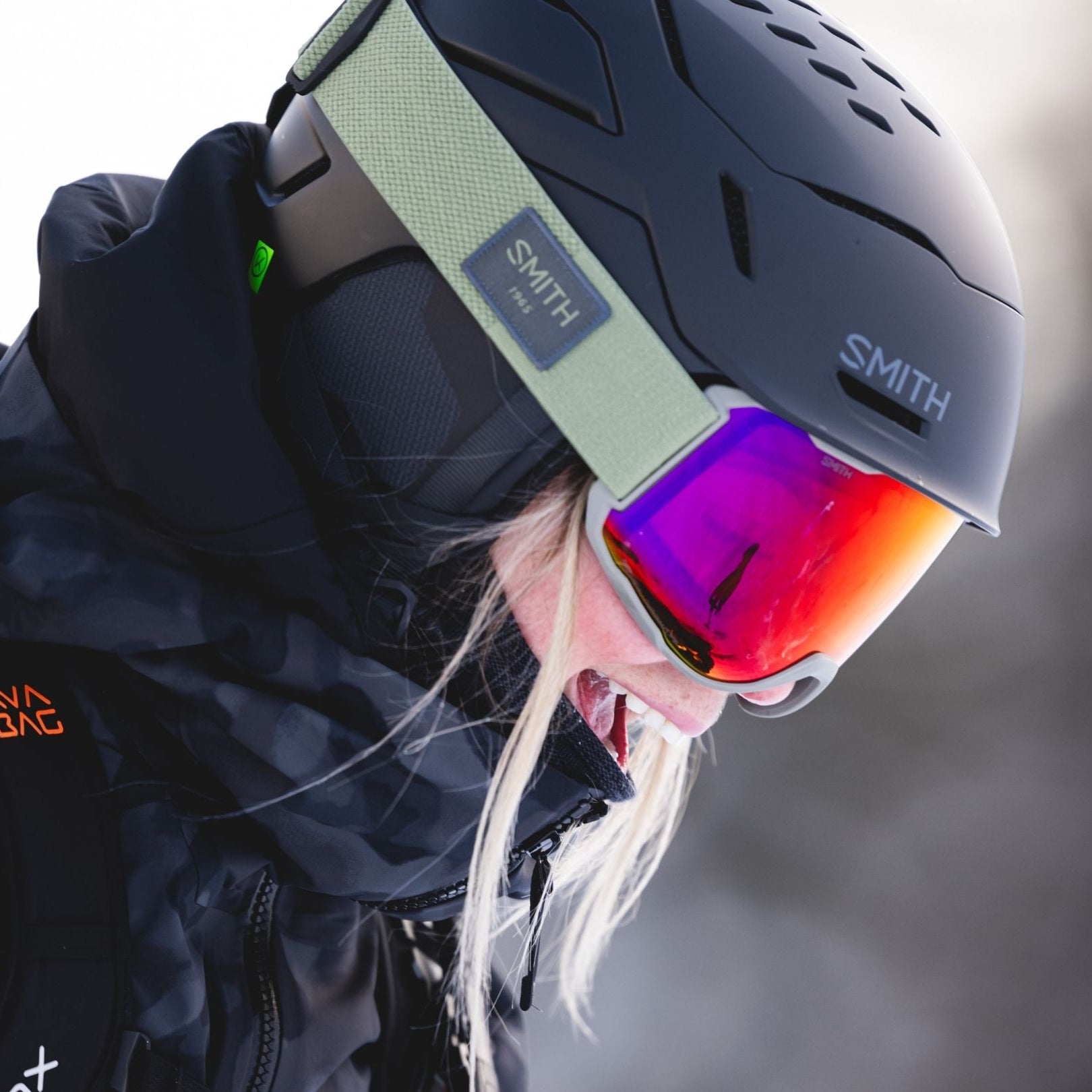 Person wearing a Smith helmet and goggles with a blurred background